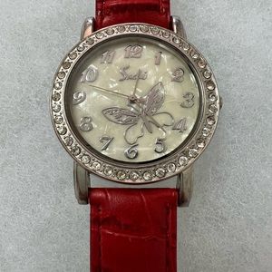 Red Lady watch with stones on bezels.